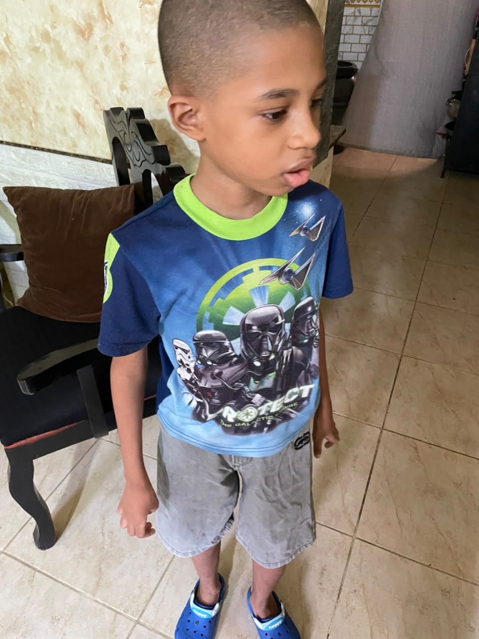 Eliseo standing in a blue shirt