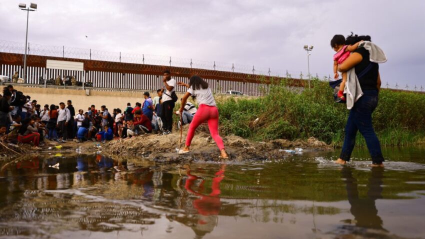 Migrants seeking asylum in the United States gather near a wire fence Sept. 12, 2023, as members of the Texas National Guard stand by to stop migrants from entering the United States after crossing the Rio Grande from Mexico. (OSV News photo/Jose Luis Gonzalez, Reuters)
